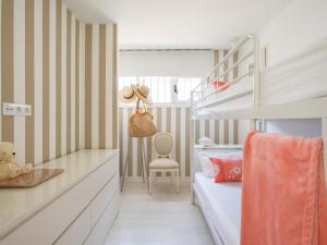 a small bedroom with a bunk bed and a desk at MY SEA VIEW HOLIDAY APARTMENT in Maspalomas +37 photos