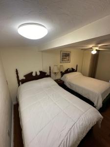 a room with two beds and a light on the ceiling at Gaard motel in Foxborough
