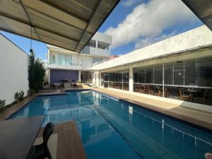 a swimming pool in front of a building at Royal Hotel e Gastronomia Macapá in Macapá
