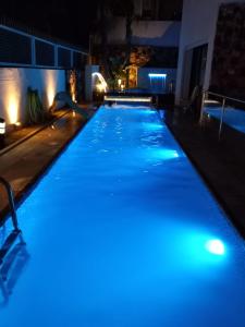 a swimming pool lit up at night with blue lights at Villa belle lune in Ariana