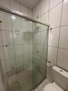 a bathroom with a glass shower with a toilet at Royal Hotel e Gastronomia Macapá in Macapá