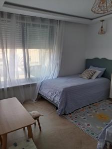 a bedroom with a bed and a window at Villa belle lune in Ariana