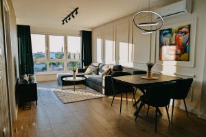 a living room with a couch and a table at Tara View Apartment in Subotica