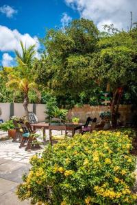 un jardin avec une table et des chaises en bois et des arbres dans l'établissement Beautiful apartment, à Willemstad