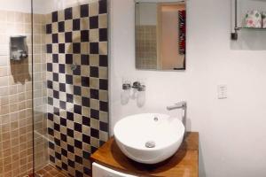 La salle de bains est pourvue d'un lavabo et d'une douche carrelée. dans l'établissement Beautiful apartment, à Willemstad