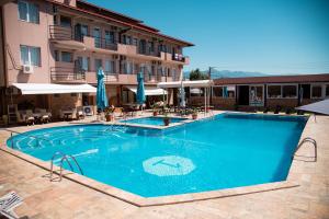 a large swimming pool in front of a hotel at Hotel Istatov in Nov Dojran