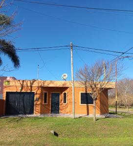 a house with a telephone pole in front of it at Lo de Vicente in Pergamino