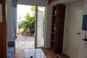 una stanza con una porta scorrevole in vetro che dà su un patio di Cozy apartment a Willemstad