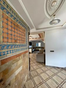 a hallway with a tile floor and a wall at villa victoria in Tétouan