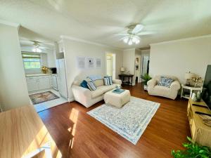 a living room with two couches and a table at Countryside Carriage House with Pool in Commerce