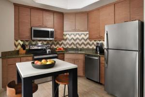 a kitchen with a refrigerator and a bowl of fruit on a table at Marriott Summit Watch 2BD Sleeps up to 8 in Park City +37 photos