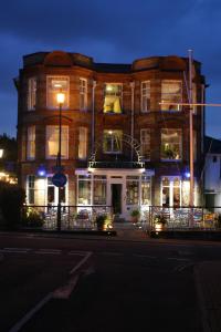 a large brick building with lights on a street at The Seaview Hotel And Restaurant in Seaview