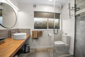 a bathroom with a sink and a shower at Cameron Road Motel in Tauranga +11 photos