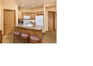 a kitchen with a island and bar stools at Worldmark Galena - 1BD in Galena