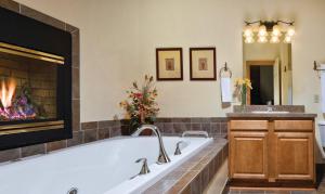 a bathroom with a tub and a fireplace at Worldmark Galena - 1BD in Galena +15 photos