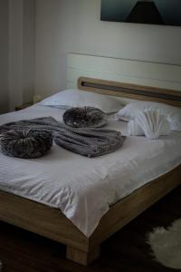 a bed with two blankets on top of it at Green Apartaments Self Check-In 24-7 Free Parking in Zărneşti
