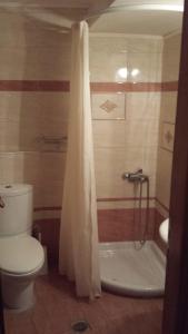 a bathroom with a shower and a toilet and a tub at Atelier in Rethymno Town
