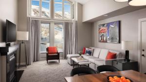 a living room with a couch and a table at Marriott Mountainside Luxury 1BD in Park City