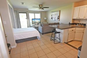 a bedroom with a bed and a kitchen with a sink at Sandpiper Cove Unit 8125 Updated Studio In Destin FL in Destin