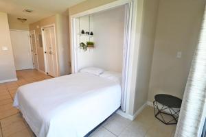 a bedroom with a white bed and a chair at Sandpiper Cove Unit 8125 Updated Studio In Destin FL in Destin +37 photos