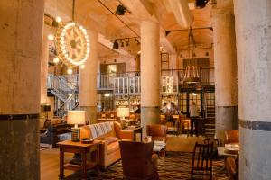 a large room with tables and chairs in a building at Southtown 3BR Cowboy Pool, Playset, Riverwalk, BBQ, Firepit, Big Yard — Downtown San Antonio in San Antonio