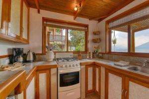 a kitchen with a stove and a sink at Chic Lakefront Retreat Casa Diamante Atitlan in San Marcos La Laguna +51 photos