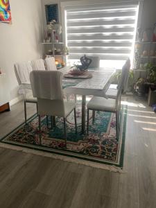 a dining room table and chairs on a rug at Empress moment place #602 in Calgary