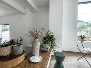 a room with vases and plants on a table at Beijing Wuji Inn - The Great Wall of China Huanghuacheng in Beijing