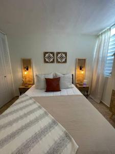 a large white bed in a bedroom with two lamps at Casa Valentina Dreamy Beach Lakeview House in Punta Santiago