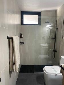 a bathroom with a shower and a toilet at Casa Valentina Dreamy Beach Lakeview House in Punta Santiago +38 photos