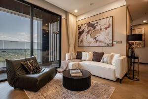 a living room with a couch and a table at Lumiere riverside-Kiri-serene unit in Thao Dien in Ho Chi Minh City