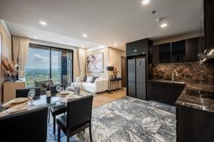 a kitchen and living room with a table and chairs at Lumiere riverside-Kiri-serene unit in Thao Dien in Ho Chi Minh City