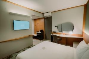 Voodi või voodid majutusasutuse Jiro Hotel toas