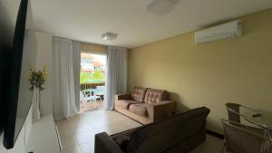 a living room with a couch and a table at Flat Condomínio Beira-Mar in Tamandaré +31 photos