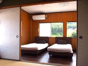 Postel nebo postele na pokoji v ubytování 那智の里 Accommodation along the Kumano Kodo trail