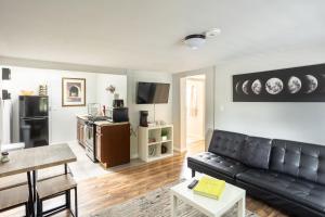 a living room with a black leather couch at Spacious Guest Suite Amazing Location in San Diego