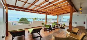 a dining room with a view of the ocean at Galapagos Apartments - Bay View House in Puerto Ayora
