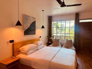 Postel nebo postele na pokoji v ubytování ODI KAMADHOO