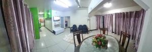 a room with a table and chairs in a hospital at Blisful rental in Nadi