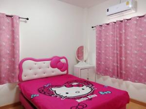 a bedroom with a hello kitty bed with a pink blanket at Chiang Mai Home in Chiang Mai