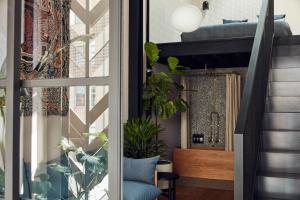 a living room with a staircase and a window at Paramount House Hotel in Sydney