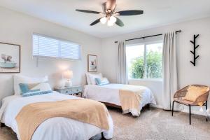 a bedroom with two beds and a ceiling fan at Beachside Bliss Spacious 3BR Retreat, Steps to Ocean in Oceanside
