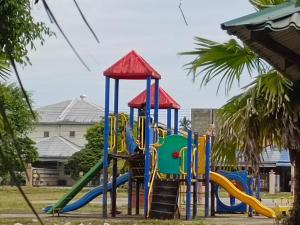 a playground with a slide in a park at Homestay Murah Lahad Datu in Lahad Datu