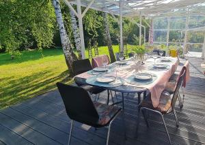 a table on a deck with chairs and a tableablish at Villa Marta in Trzebinia +30 photos