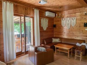 a living room with a couch and a table at Rzeka i las in Urad