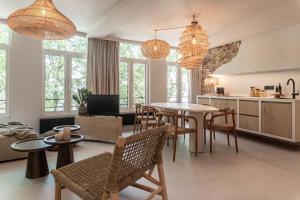 a living room with a table and chairs and windows at Perfect-Stay in Antwerp