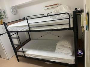 Postel nebo postele na pokoji v ubytování 新宿In