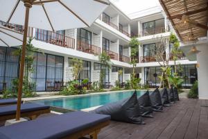 an image of the courtyard of a hotel with a swimming pool at Tegal Wangi Canggu in Canggu