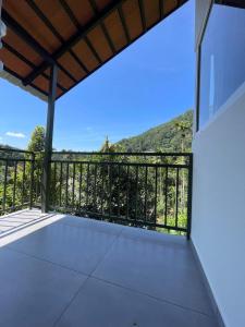 a balcony with a view of a mountain at Nutmeg shades Cottage in Anachal