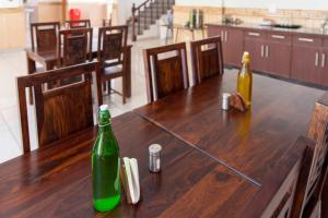a wooden table with two bottles on top of it at Zamling Donkhang Tabo in Tabo